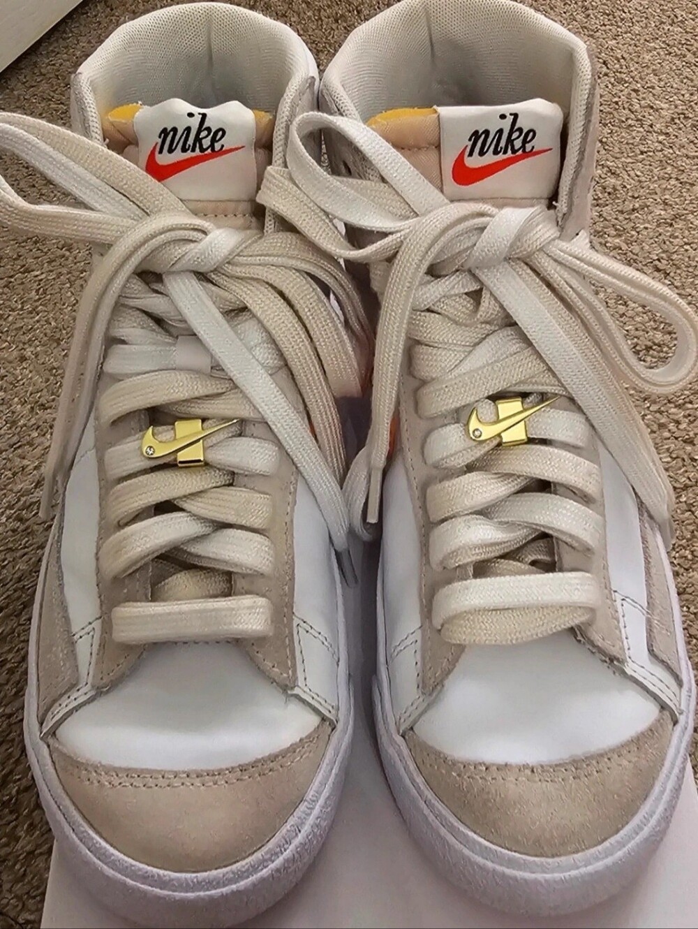 Nike Special Edition White High-Top Sneakers with Orange Stripe.